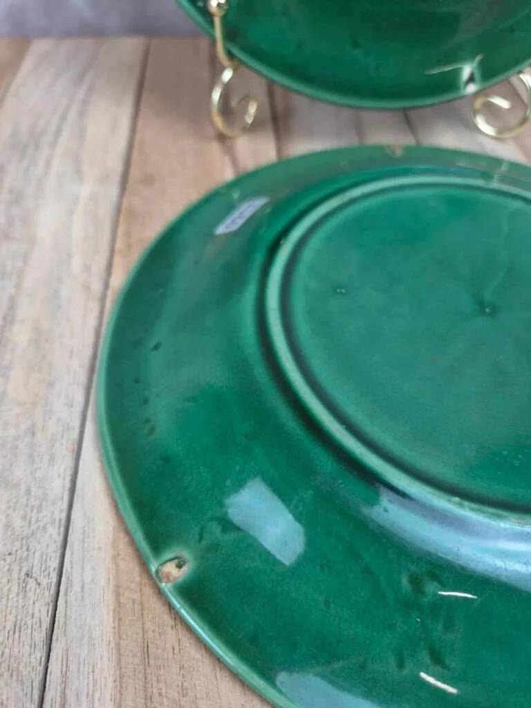 Set of 2 green earthenware dessert plates with vine decoration.