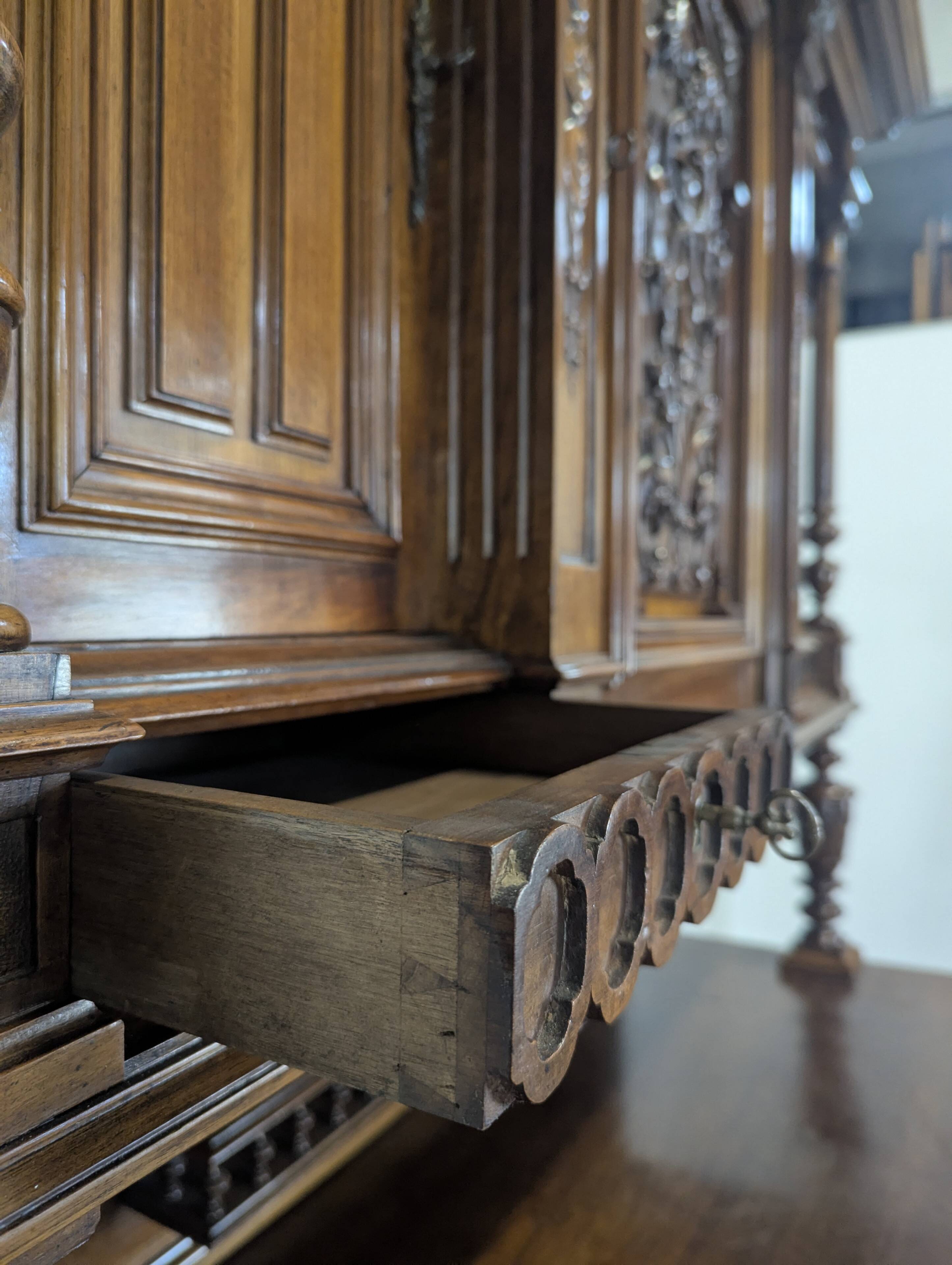 Large buffet with 2 bodies in Renaissance style made of solid walnut.