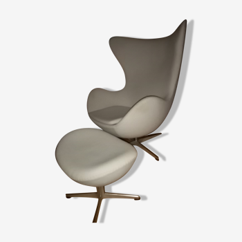 Egg armchair and its footrest designed by Arne Jacobsen