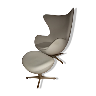 Egg armchair and its footrest designed by Arne Jacobsen