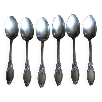 A set of 6 silver-plated metal soup spoons with foliage design.