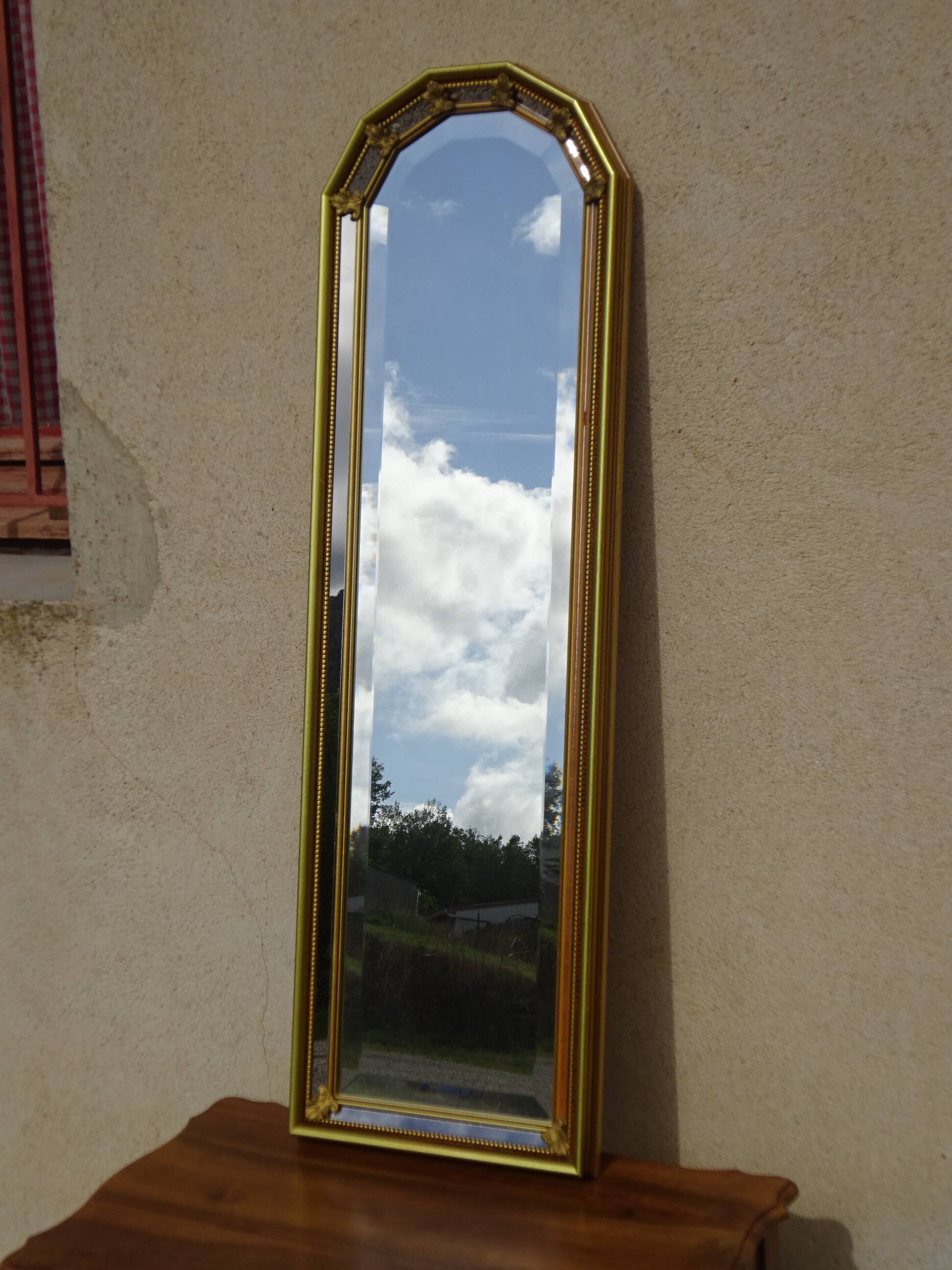 Hall mirror, gilded frame with fillets and fleur-de-lis.