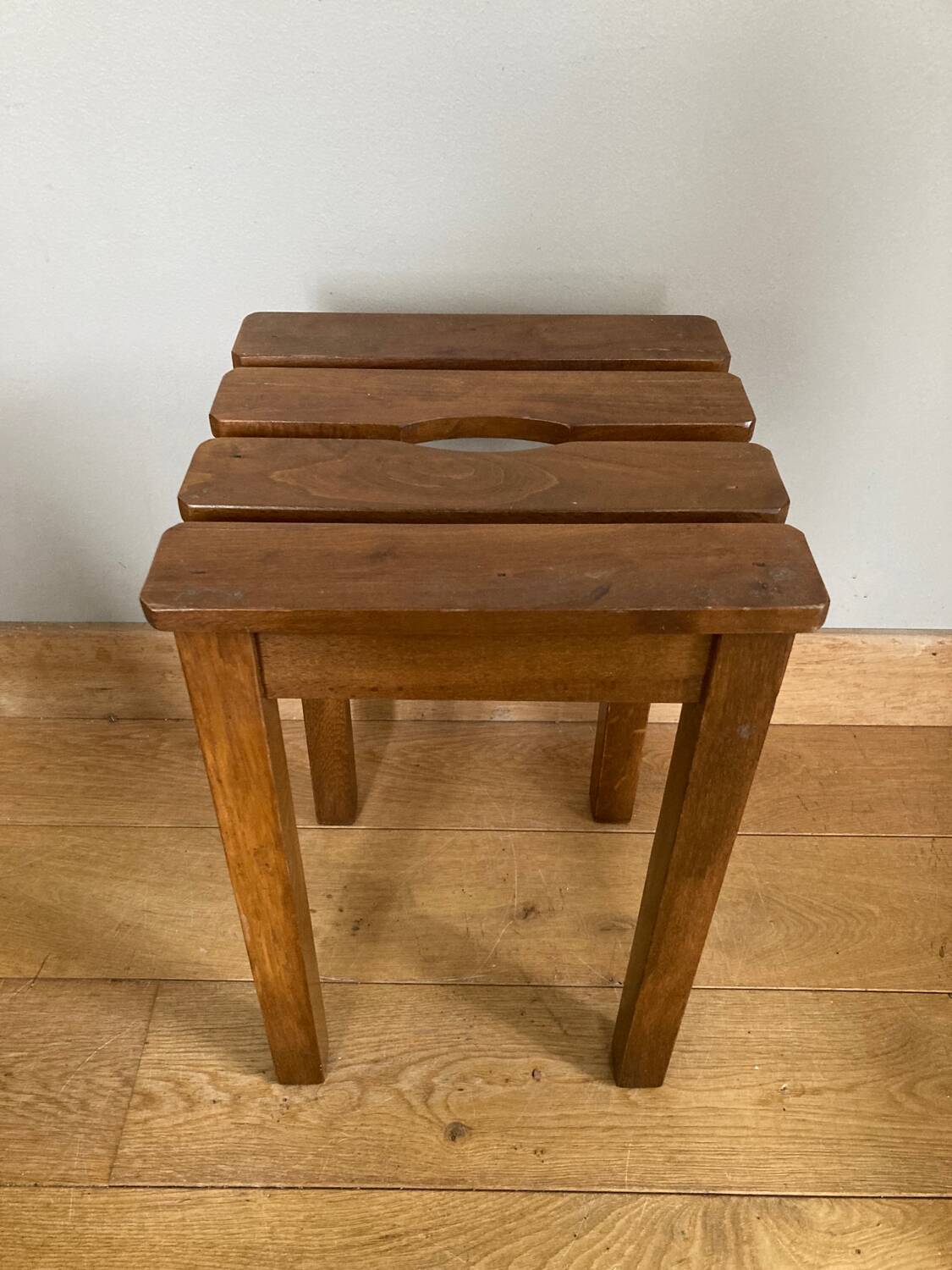 Wooden stool with central grip, quadripod base, 20th century