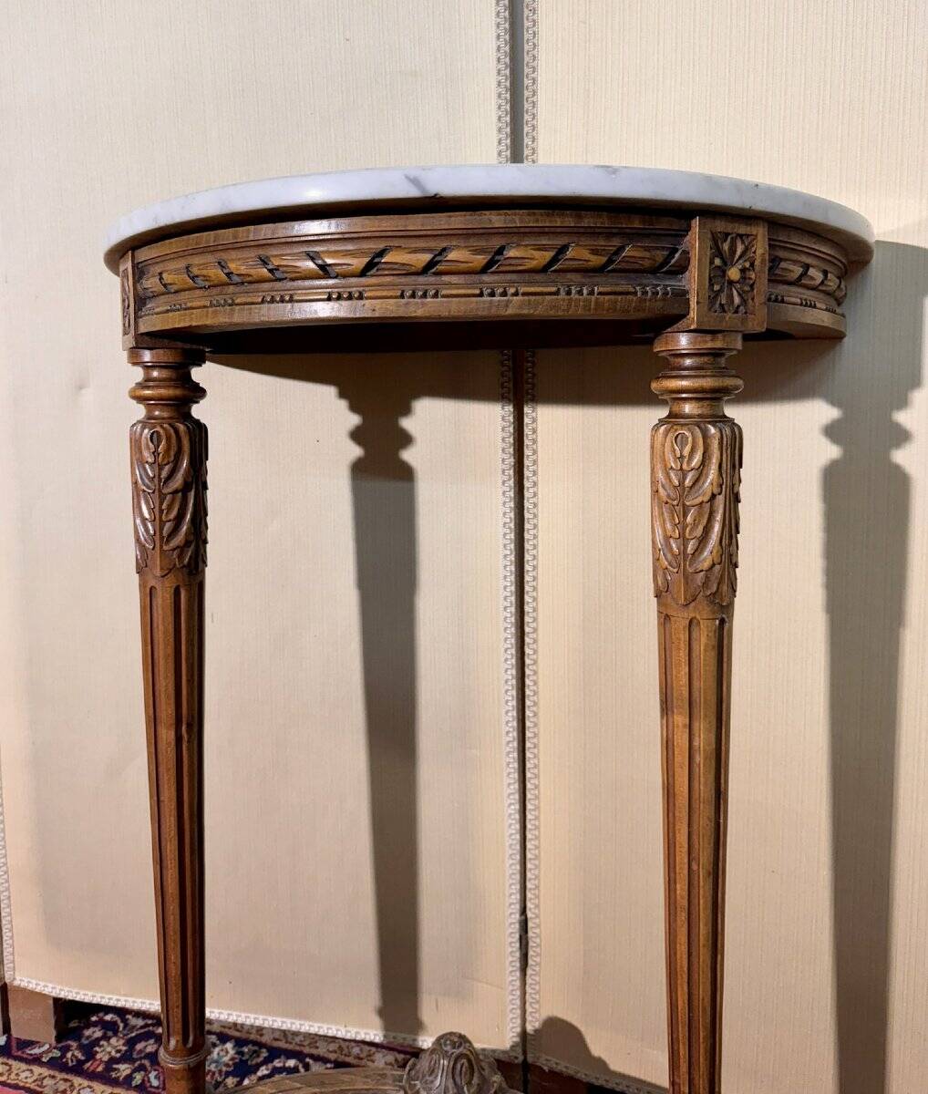 Half-moon console in Louis XVI style made of carved wood.