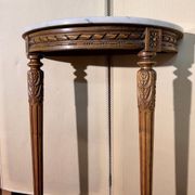 Half-moon console in Louis XVI style made of carved wood.