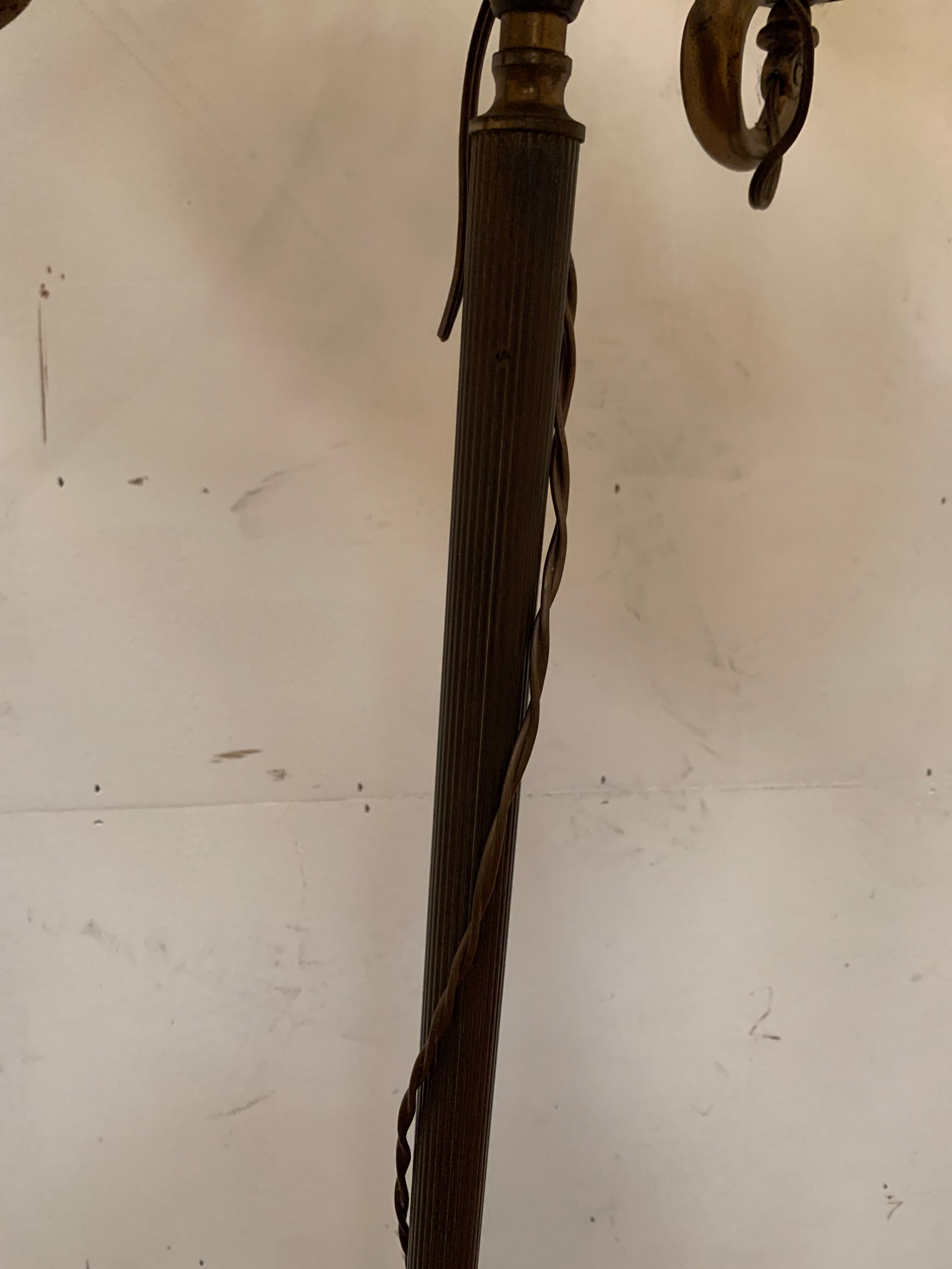 Floor lamp has three brass light arms