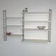 Vintage Nisse Strinning wall rack with 7 white shelves