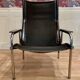 Pair of reclining black leather armchairs, "Hans Eichenberger" design, 19