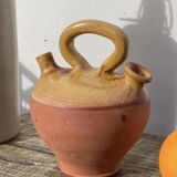Gargoulette or old jug in yellow glazed terracotta