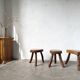 Set of three rustic solid wood tripod stools.