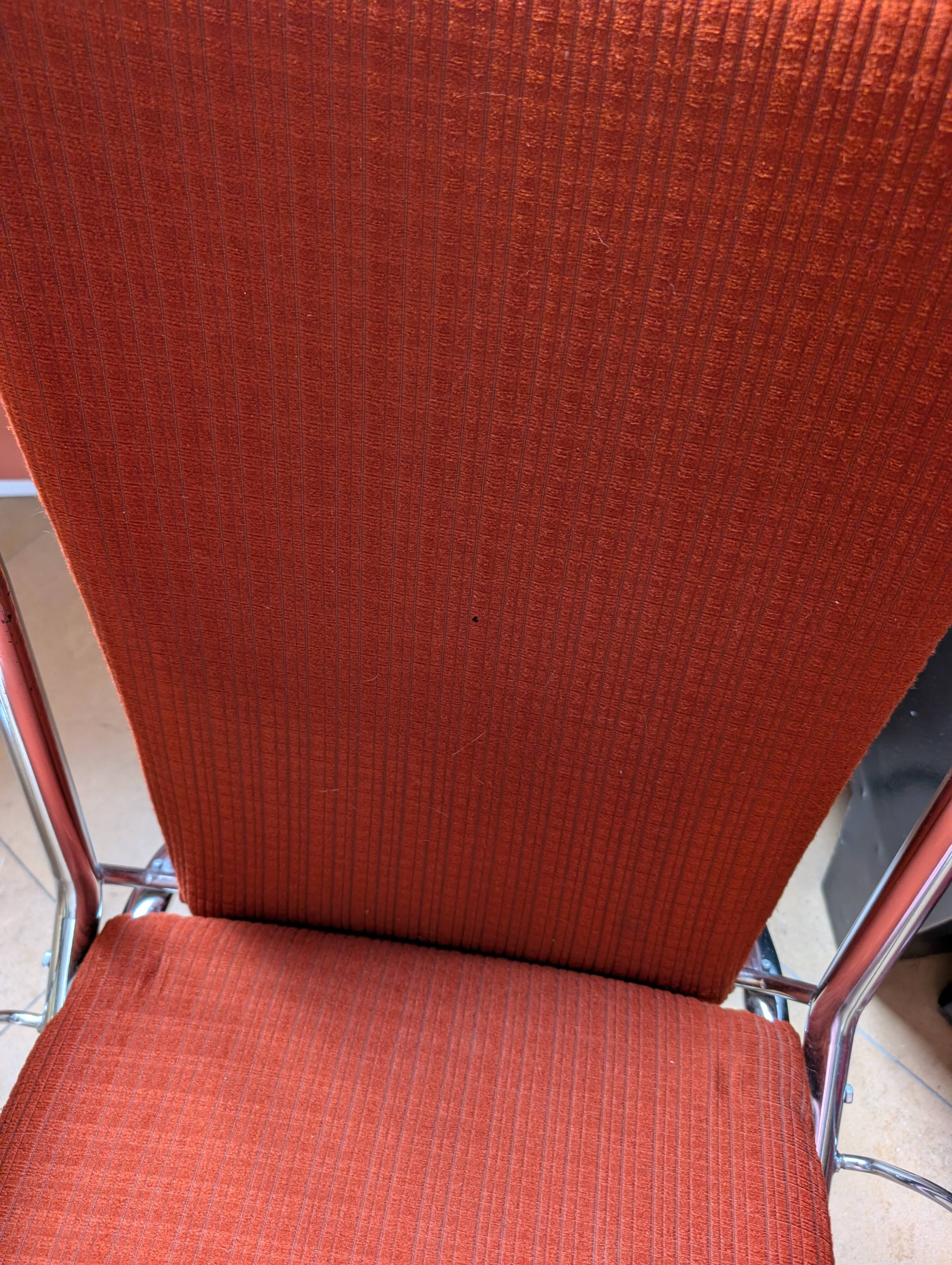 Pair of vintage folding chairs in terracotta fabric.