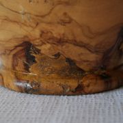 Artisanal turned olive wood vase with varnish.