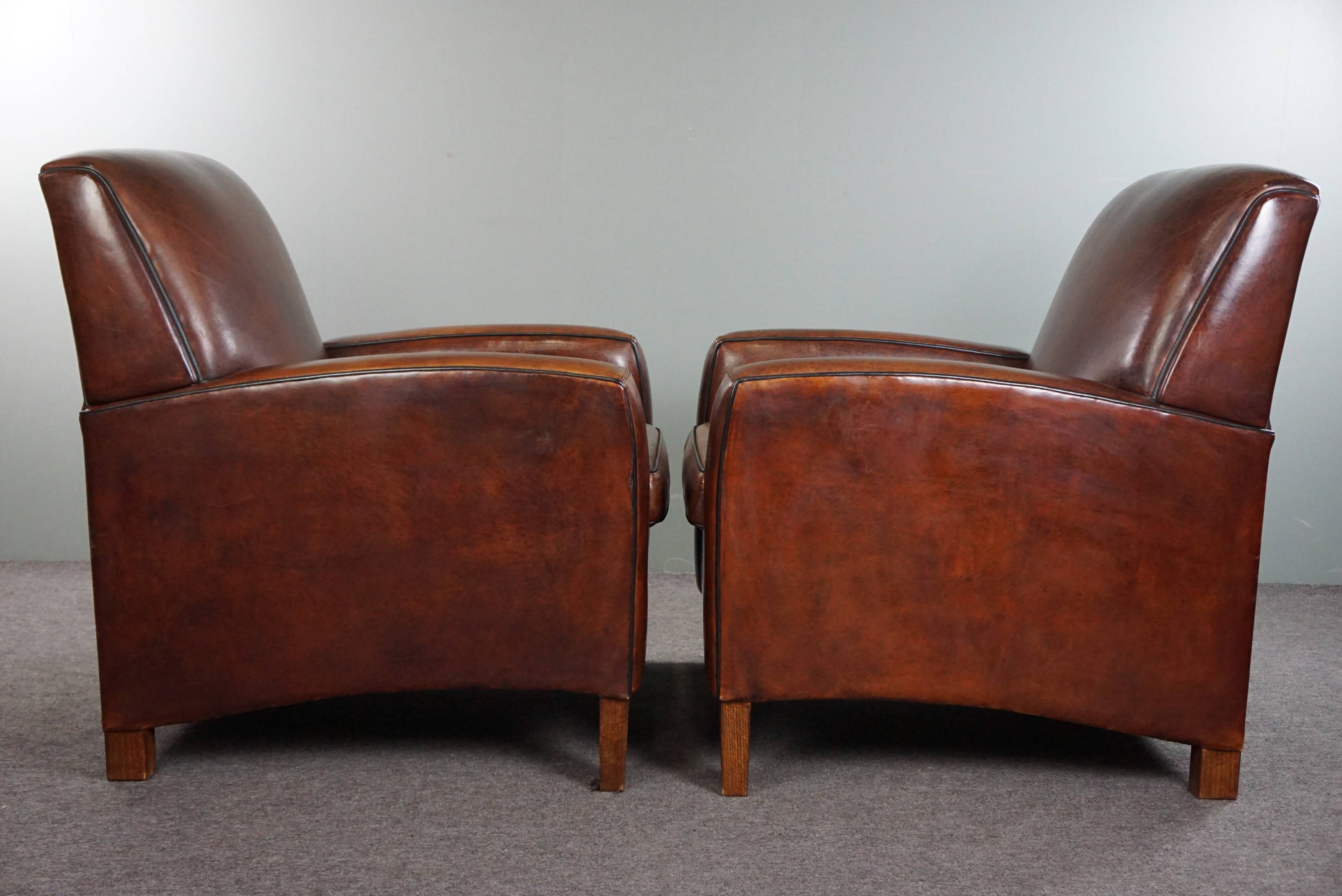 A very beautiful set of 2 Art Deco design armchairs in sheep leather