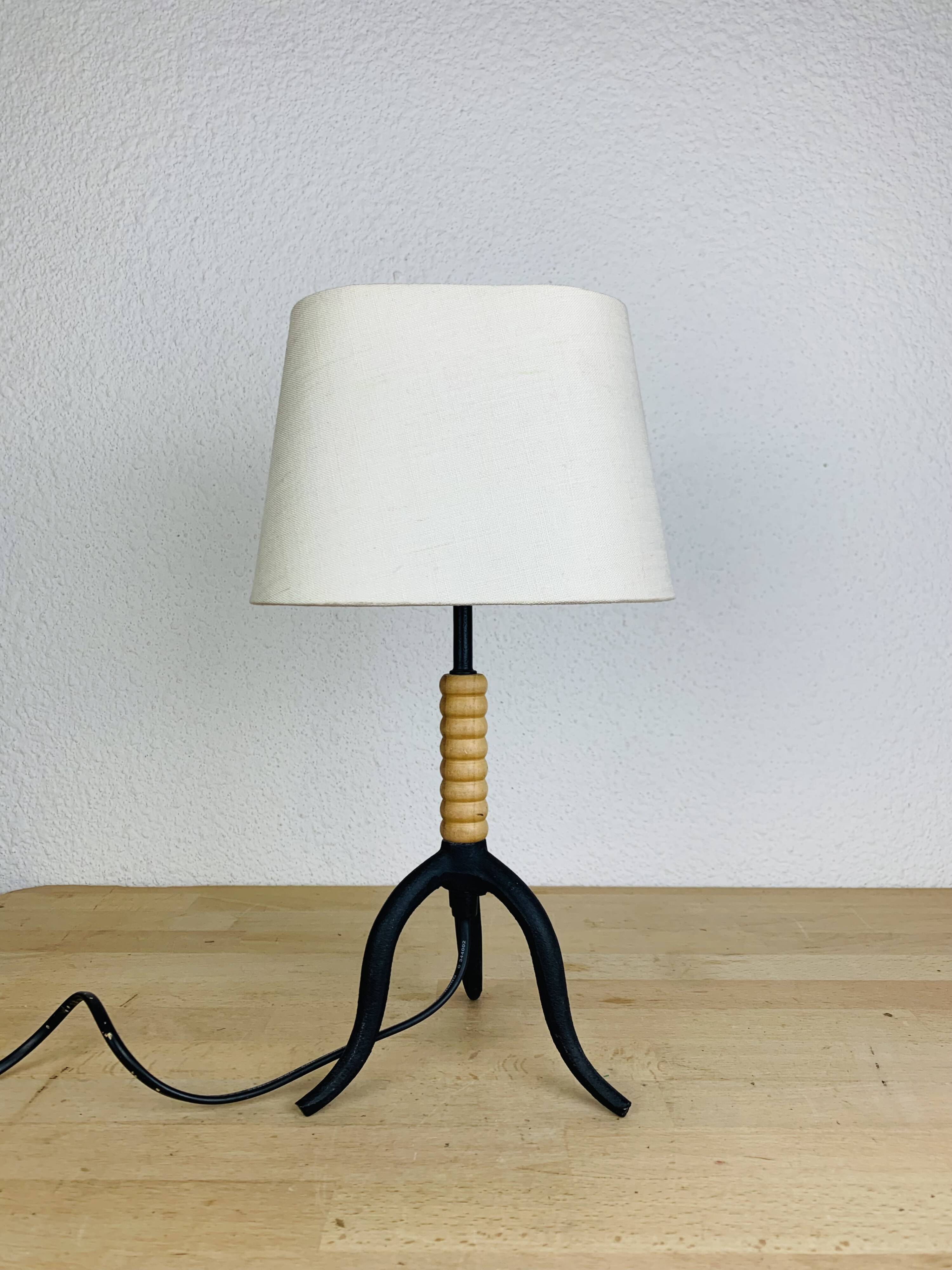 Wrought iron and wood tripod lamp
