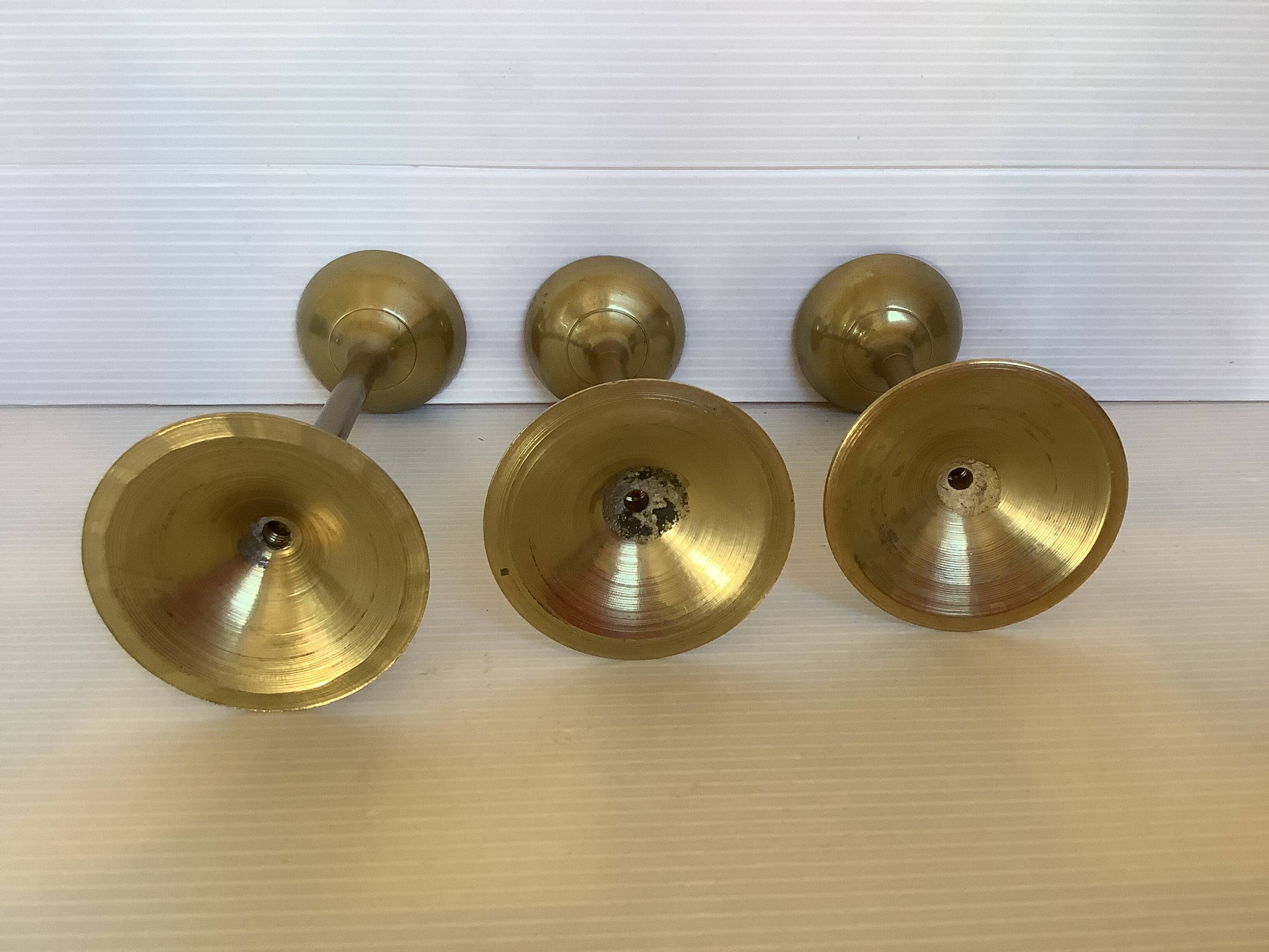 Trio of brass tulip foot candle holders