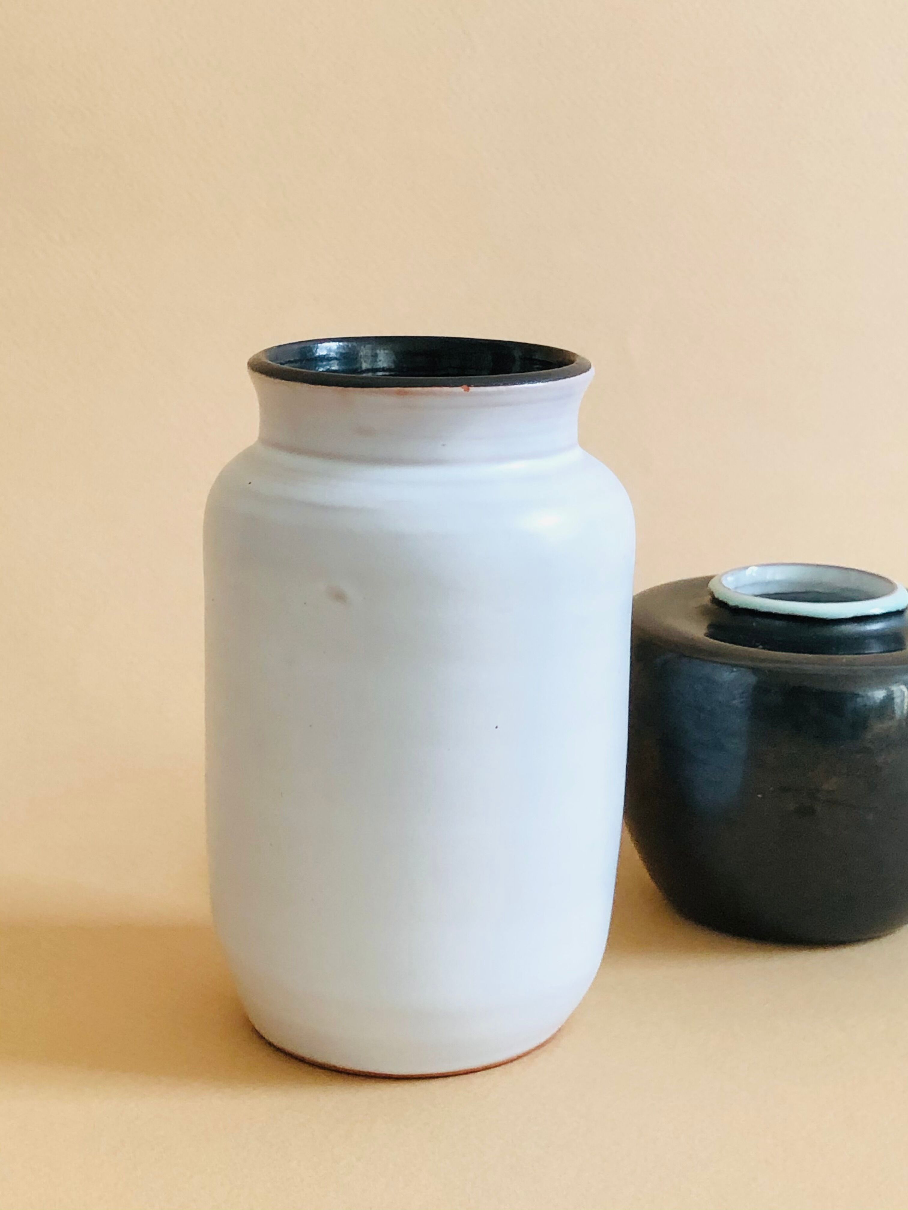 Duo of small black and white ceramic vases