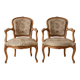 Pair of Louis XV/XVI armchairs in carved wood and floral fabric.