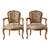 Pair of Louis XV/XVI armchairs in carved wood and floral fabric.