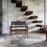 Small antique Indonesian bench in carved teak with plant and floral motifs.