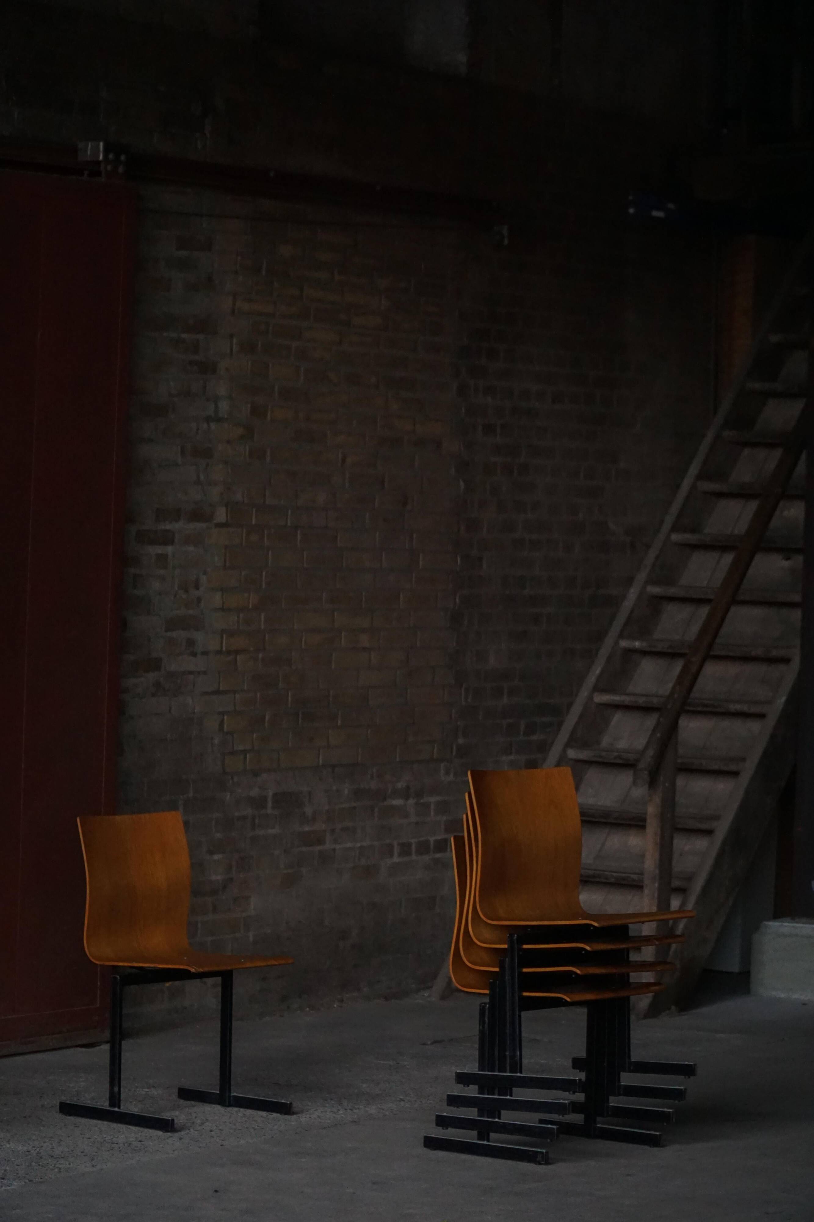 Set of 6 industrial stackable chairs by Niels Larsen, black metal and oak, 1960s.