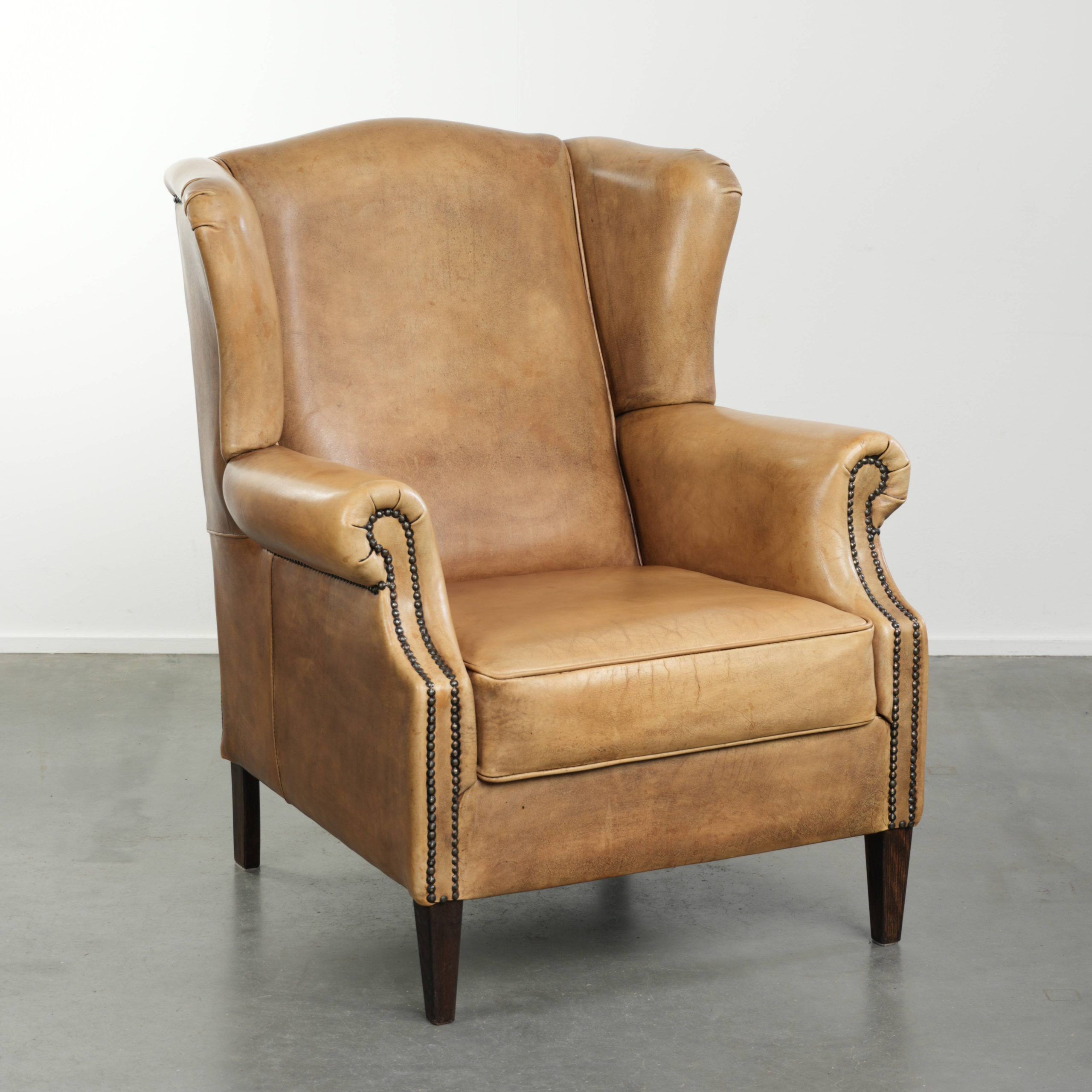 Comfortable cowhide wingback armchair with a timeless English look
