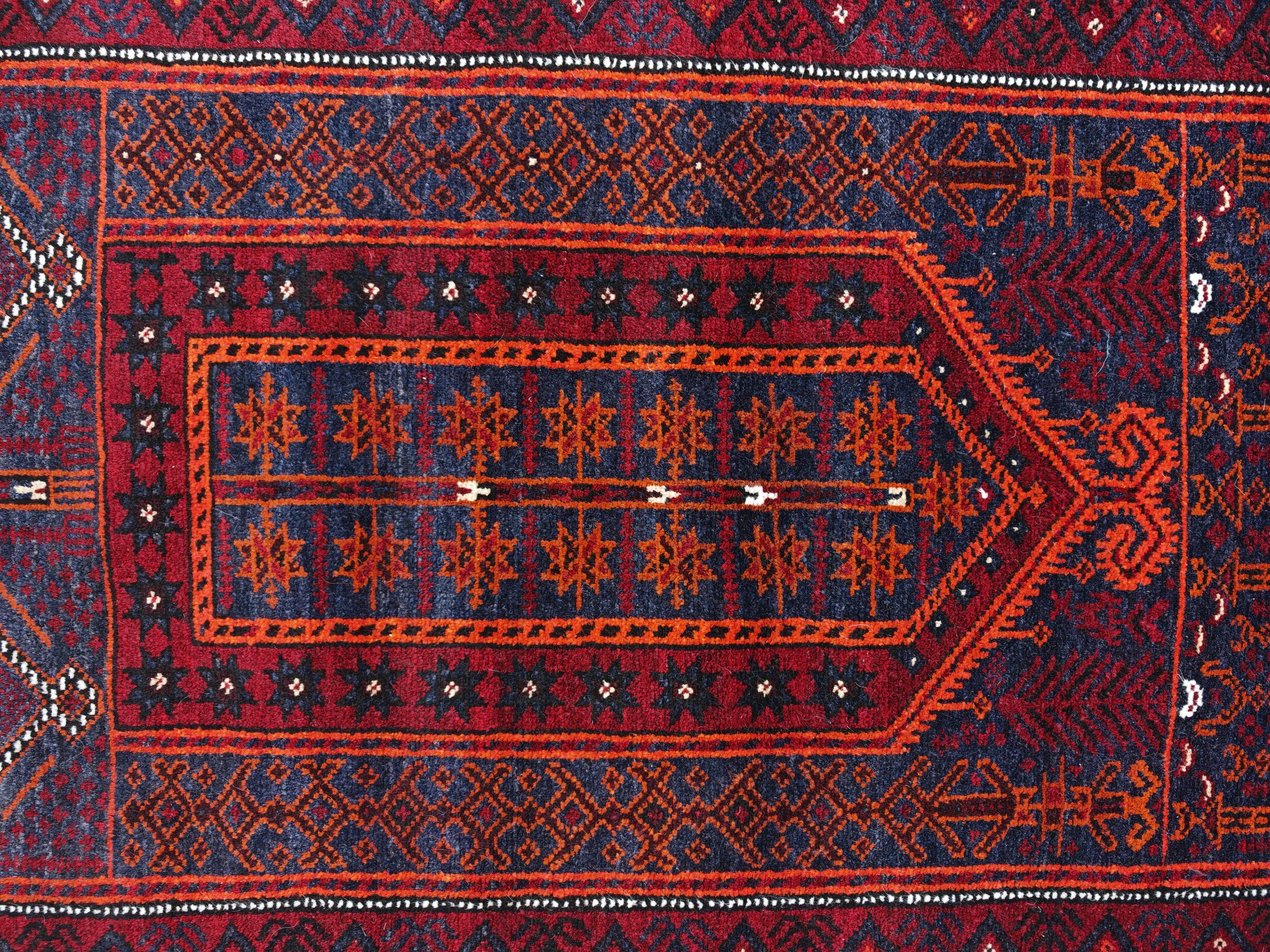 Vintage hand-knotted Persian Baluch prayer rug from the 1940s.