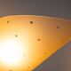 Set of three brass sconces with decorated yellow glass shades