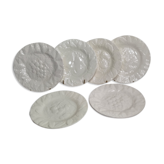 Set of six white enamelled ceramic dessert plates with fruit decorations
