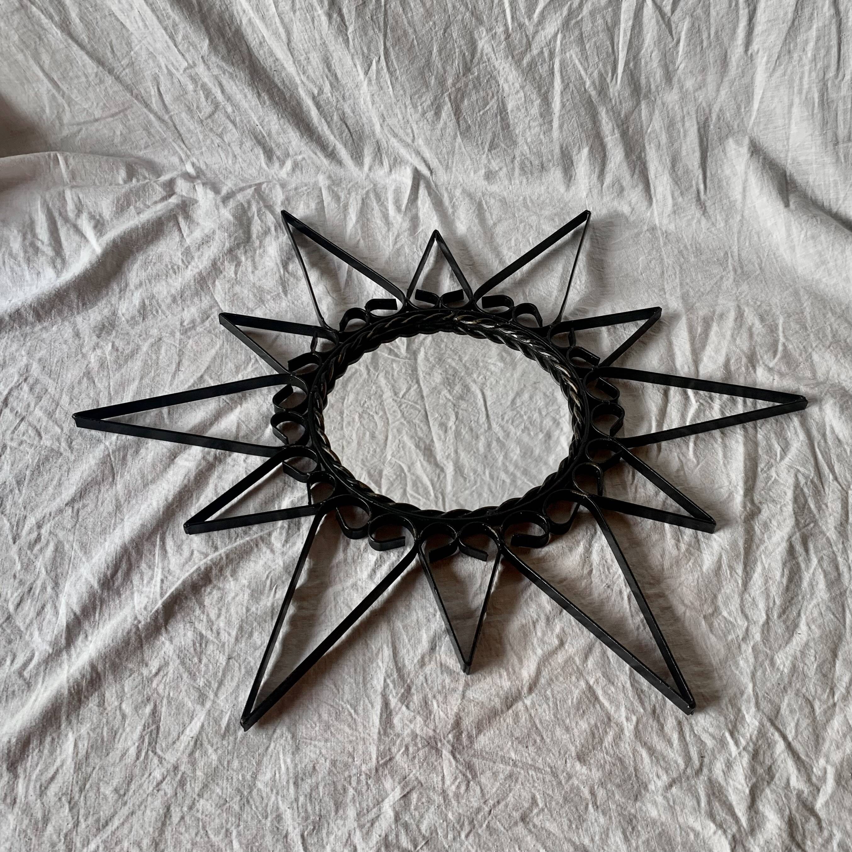 Old wrought metal sun mirror