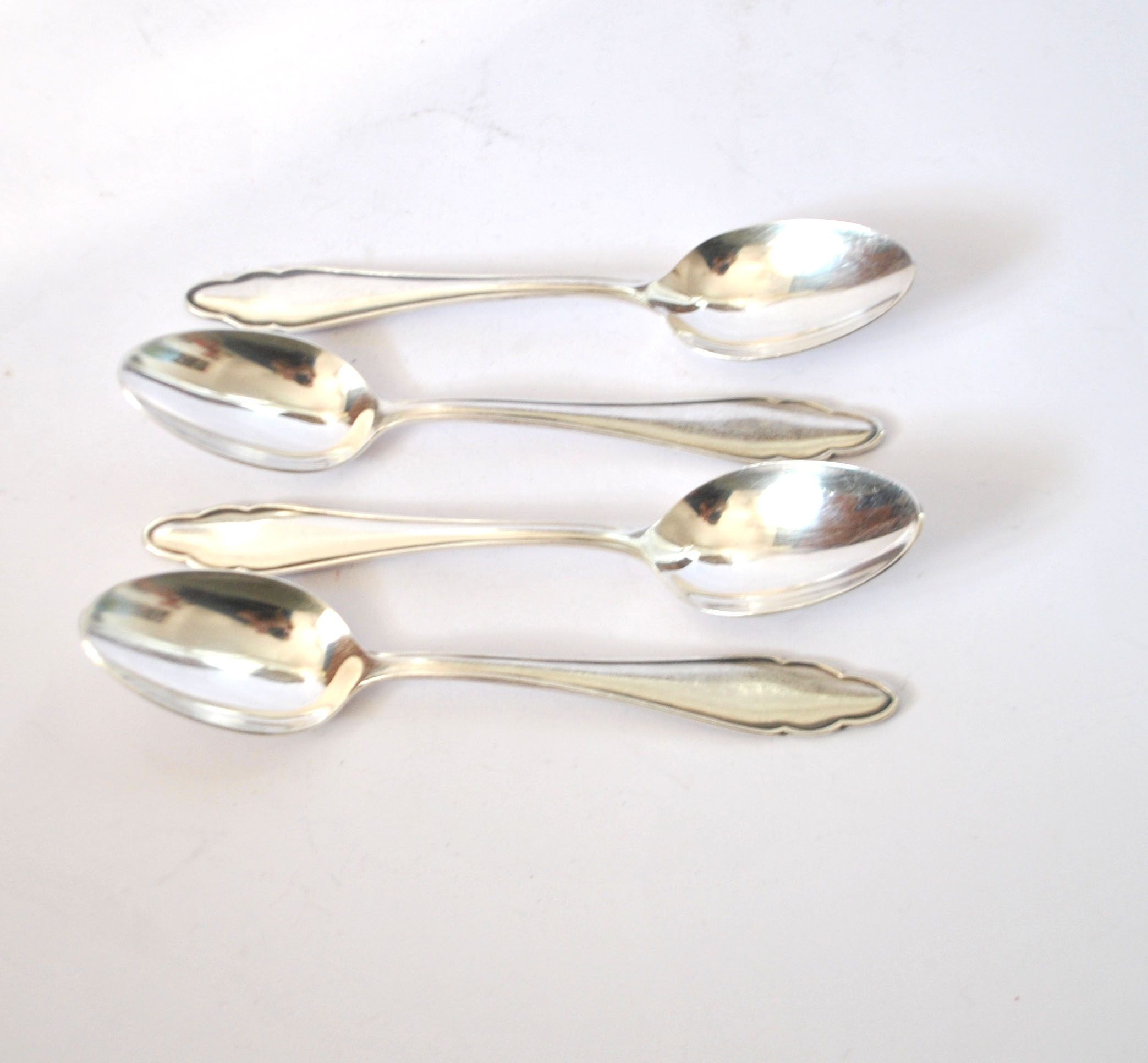 DEETJEN set of 4 silver-plated dessert spoons with a modernist scalloped design.