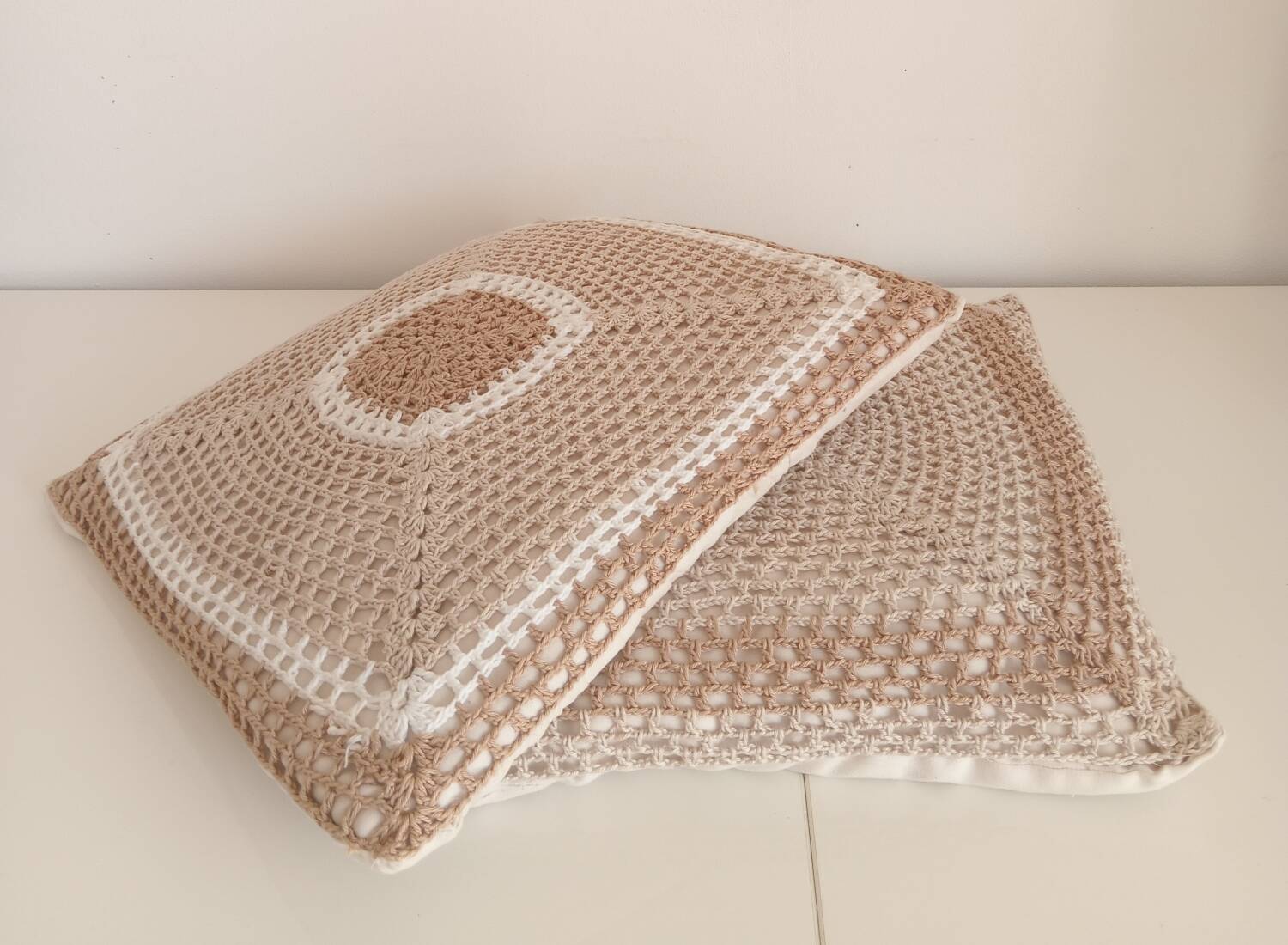 Pair of crocheted cushions