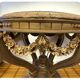 A round Louis XV style table in carved gilt beechwood with a black marble top