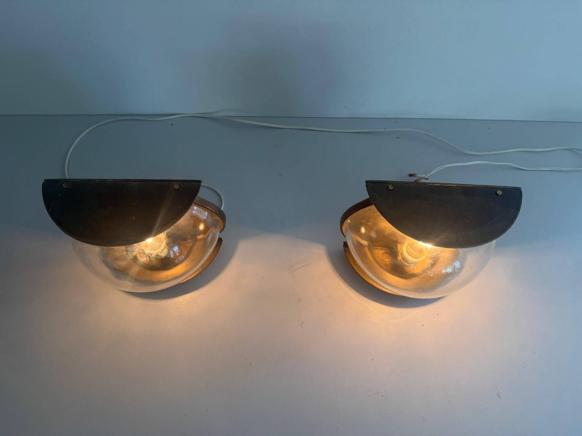 Pair of bronze and glass wall lights from the mid-century, 1960, Italy.