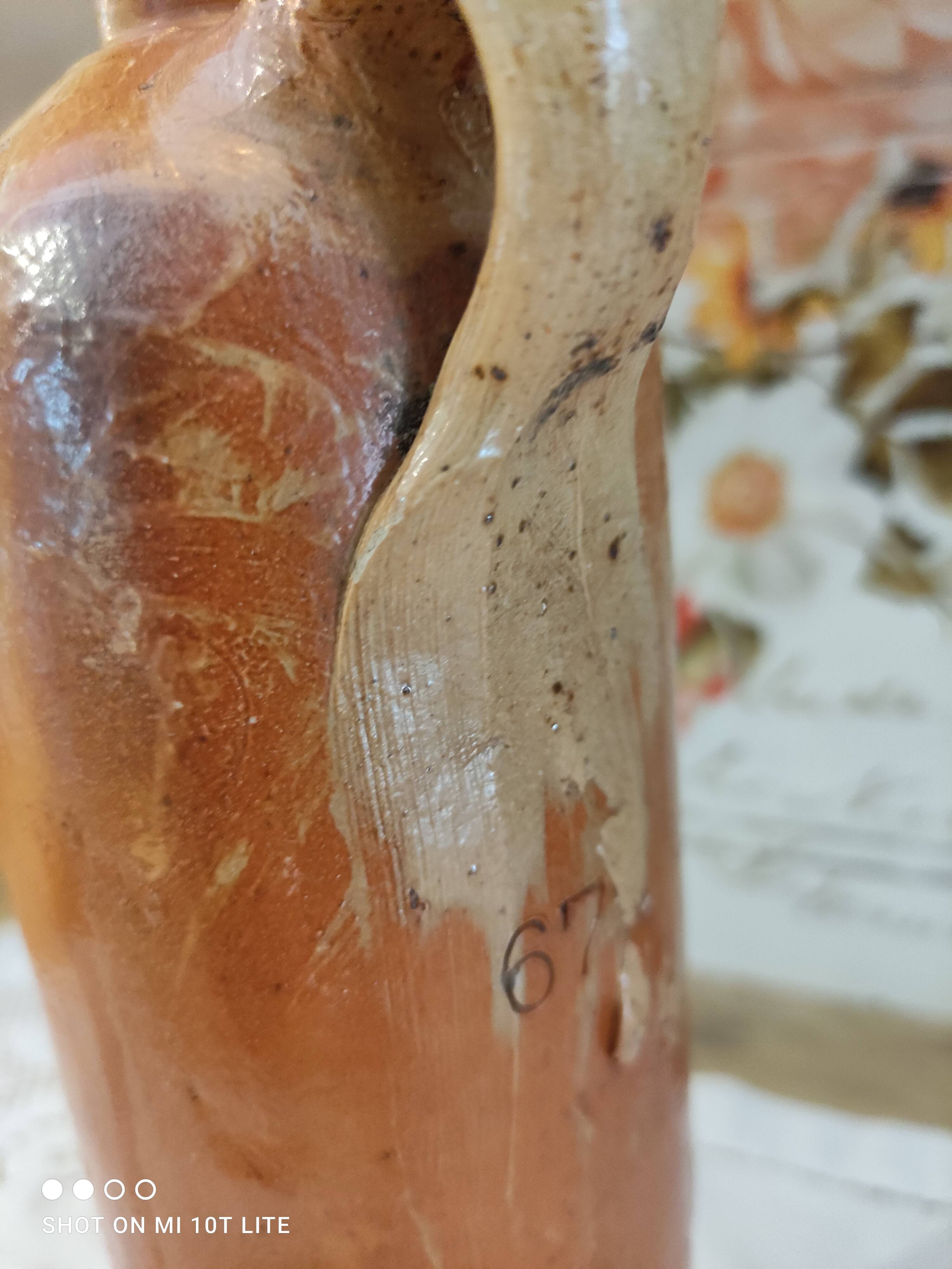 Old bottle in terracotta varnished finish