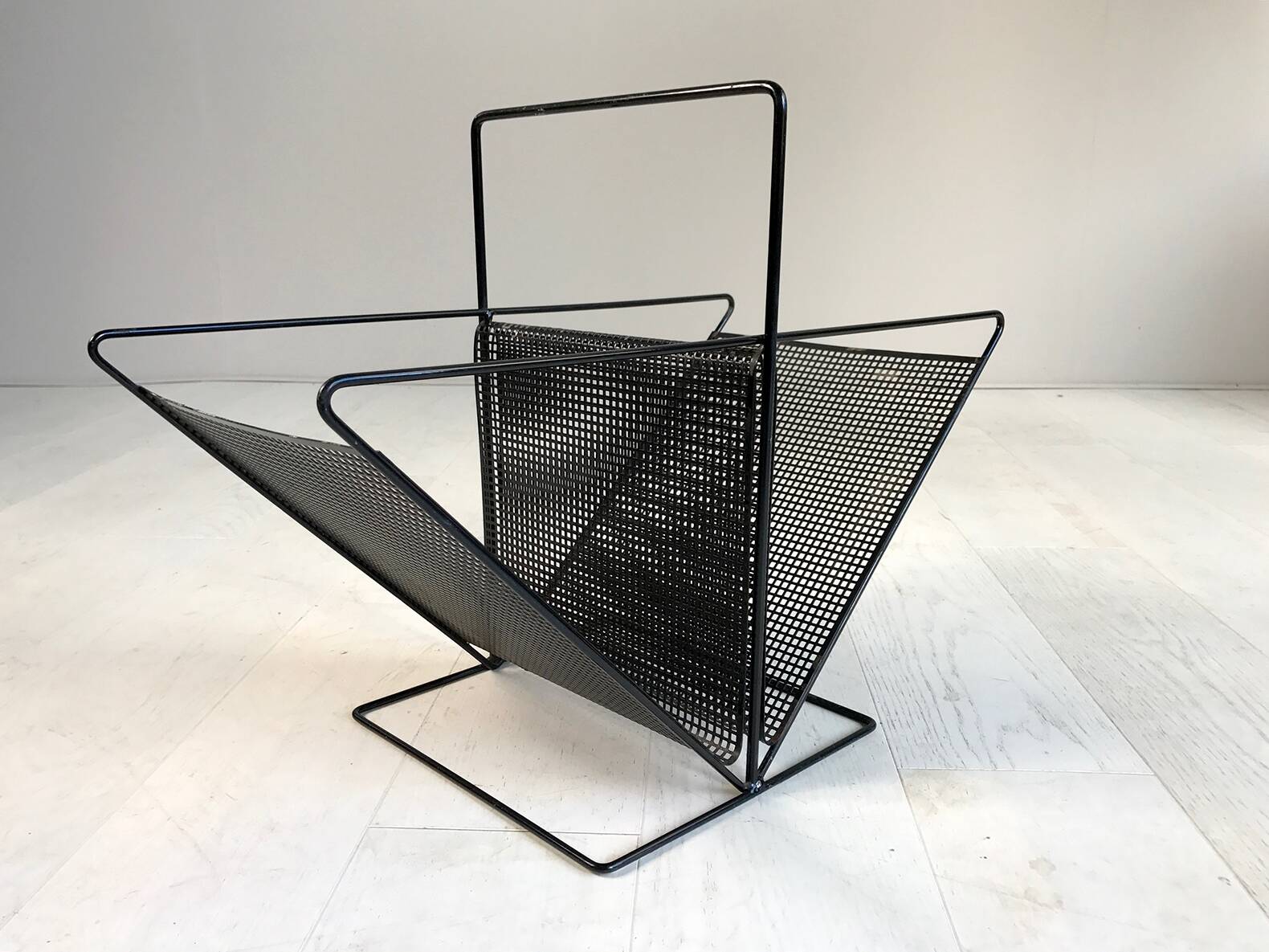 Perforated sheet metal magazine rack, 1960