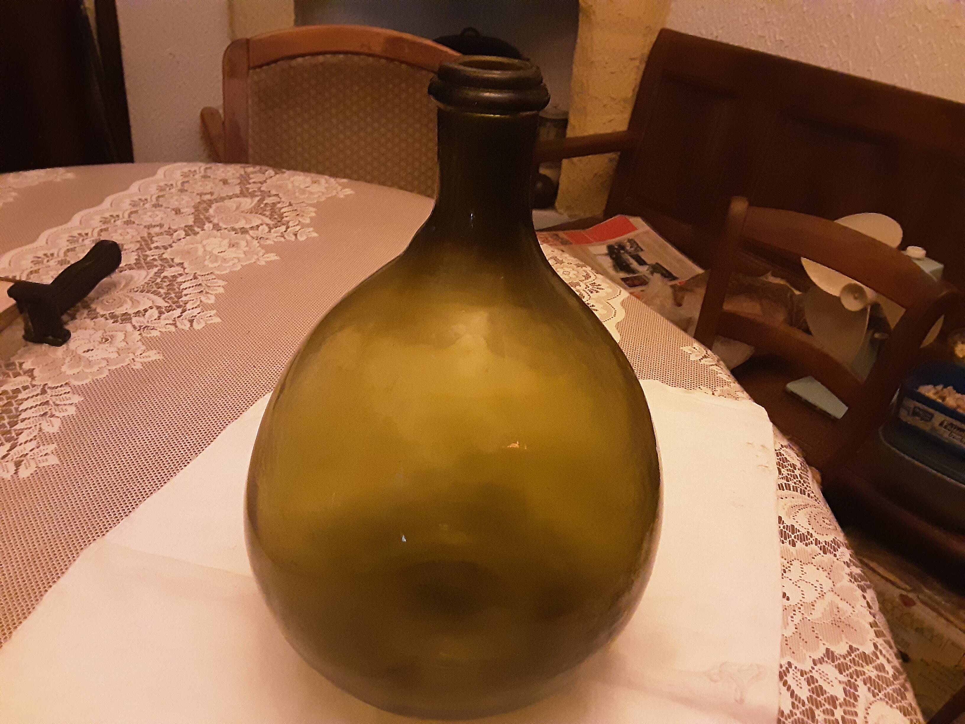 Old green glass demijeanne