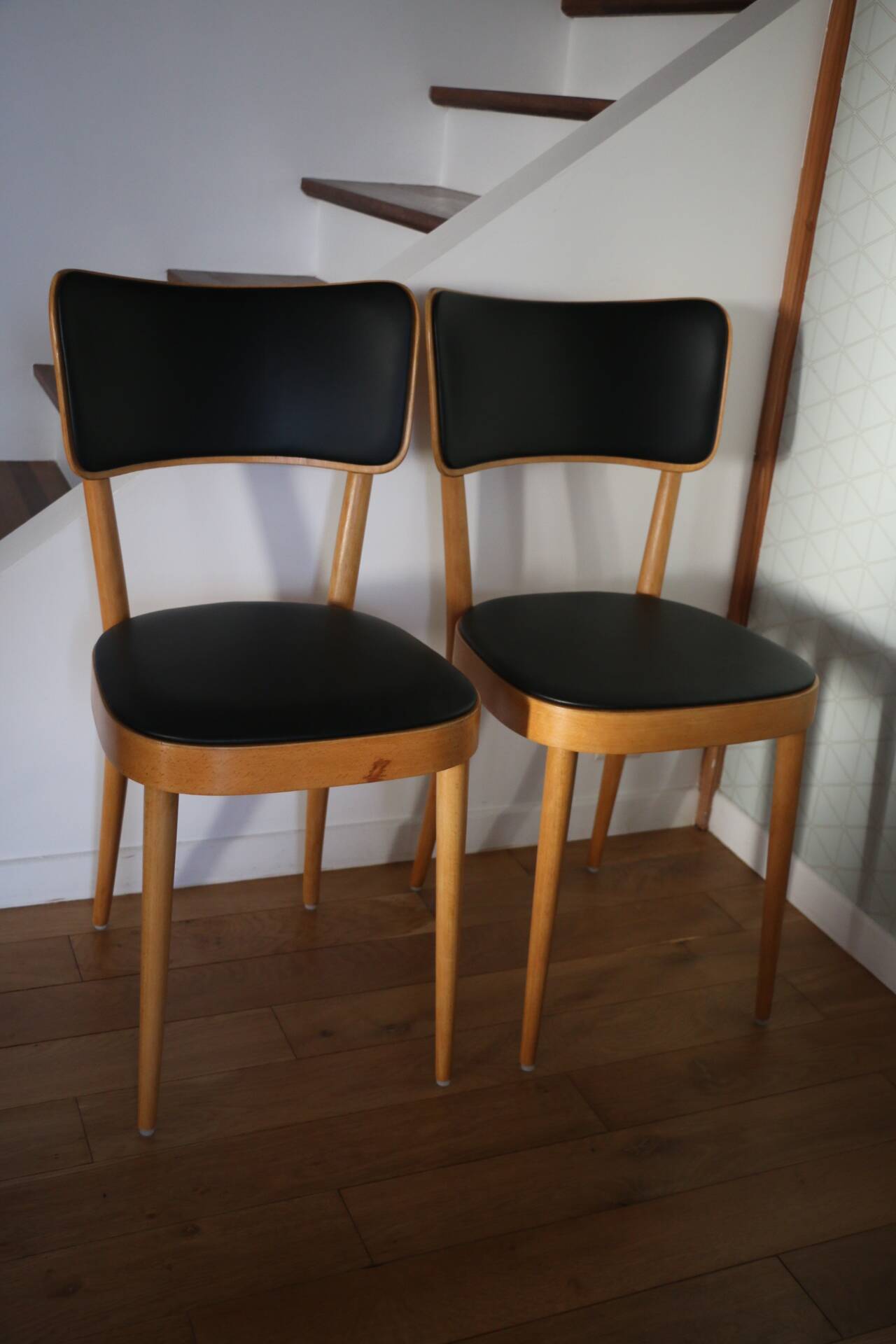 5 baumann chairs with large backs in black faux leather.