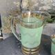 Serve an orangeade, a carafe and 3 glasses in green granite with golden trim.