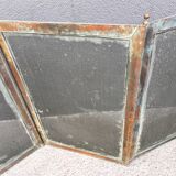 Antique fireplace screen in copper and brass from the 19th century.