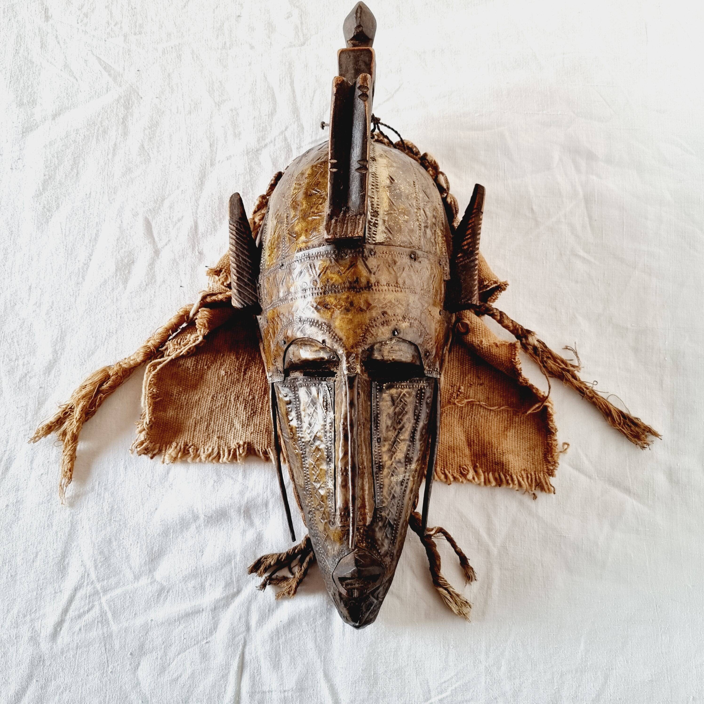 African mask from Mali from the N'Tomo tribe of Marka covered in chiseled brass