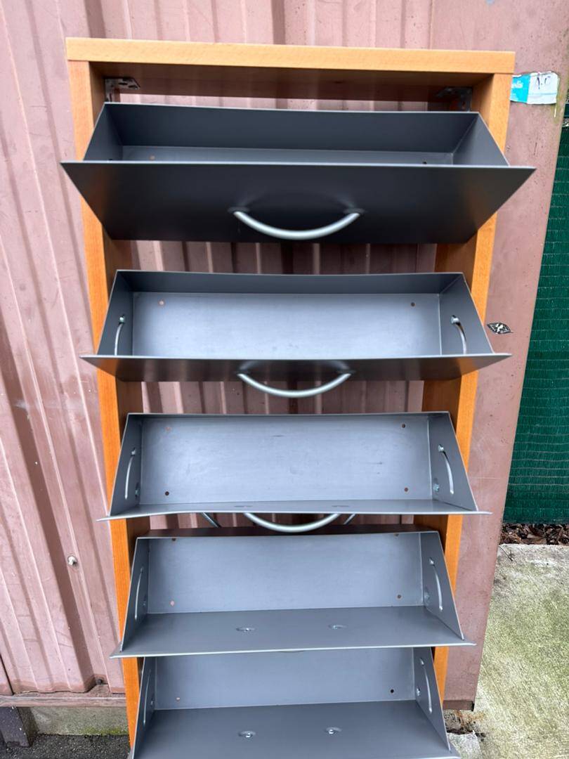 Scandinavian shoe storage cabinet in grey wood and metal.