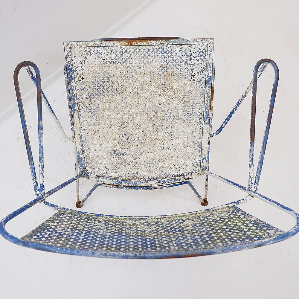 Vintage perforated metal armchair from the 1950s.