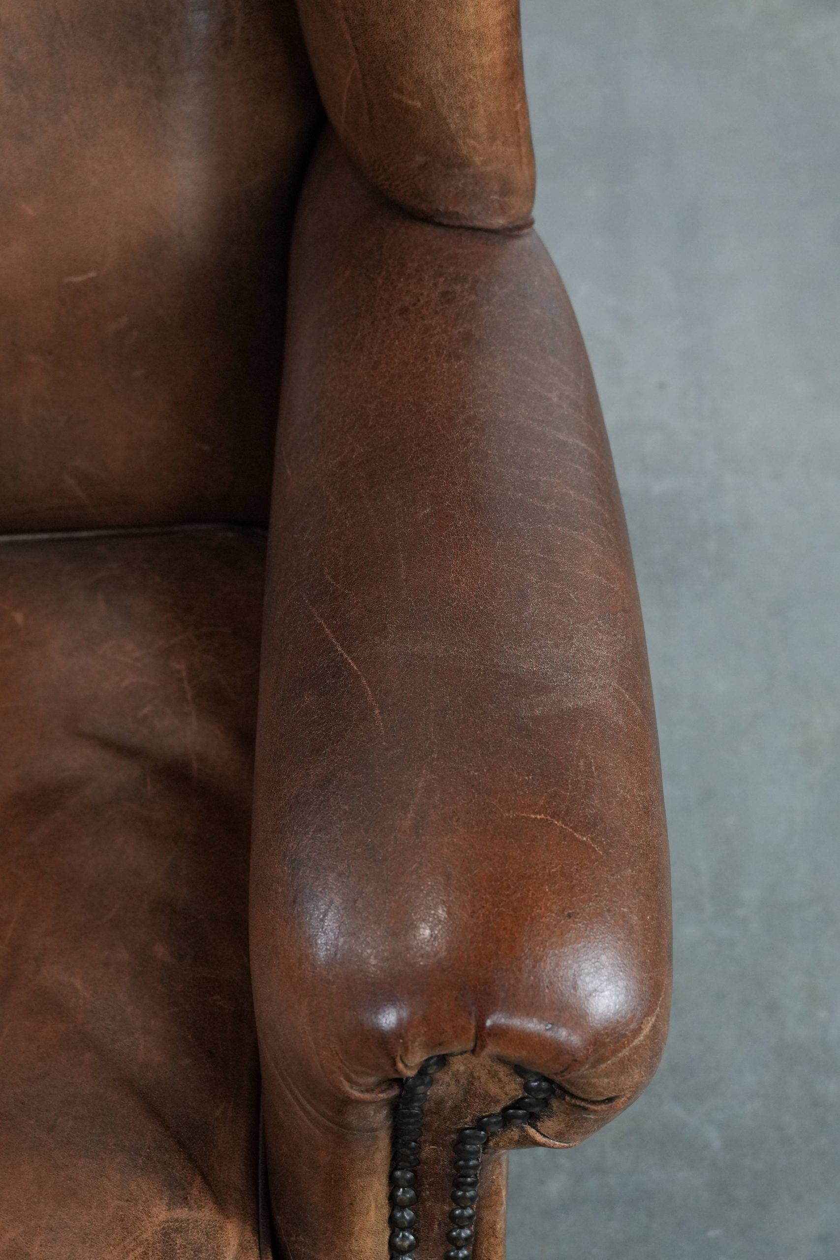 Warm, cosy and comfortable vintage sheepskin ear armchair with character