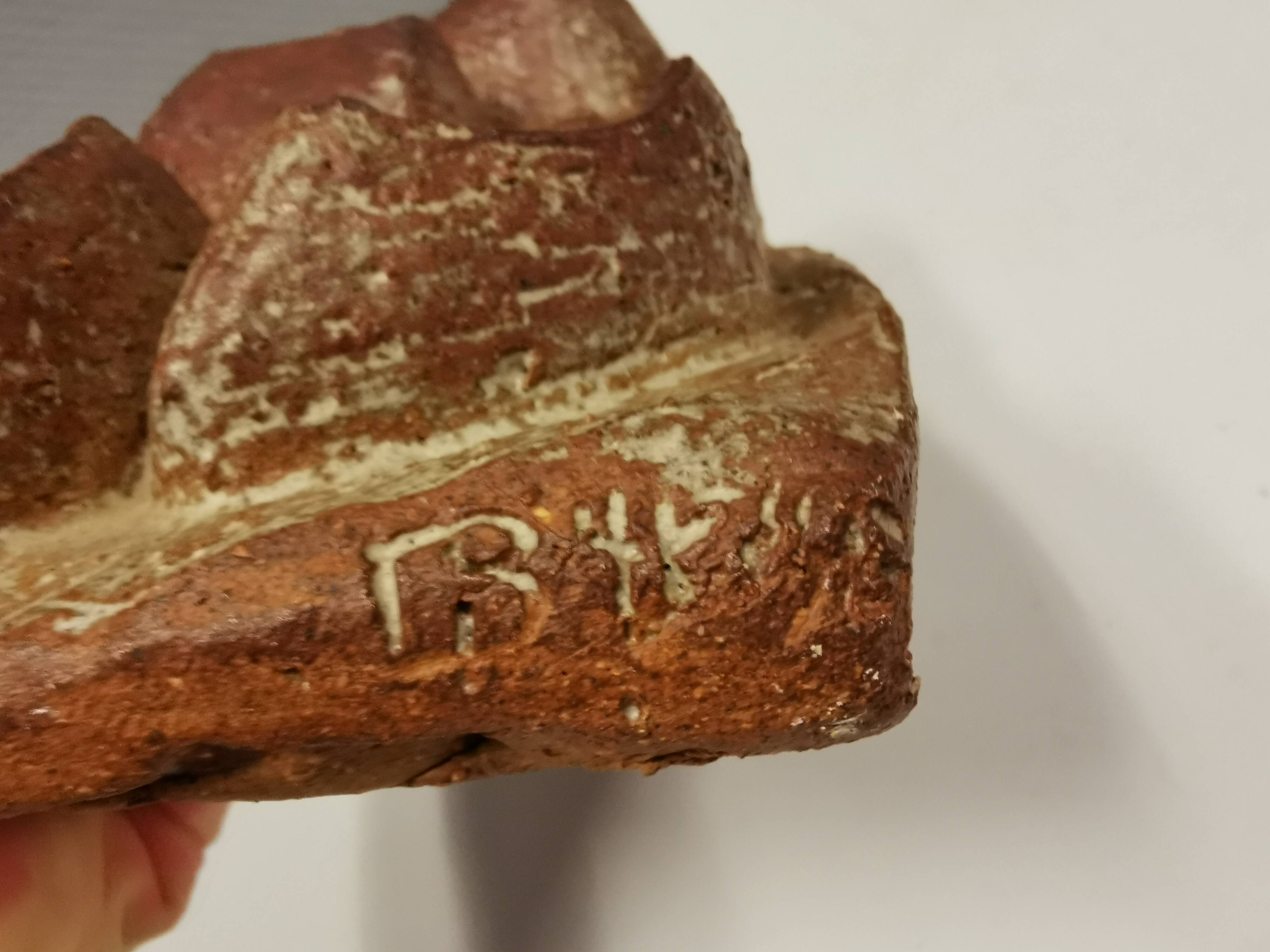 Ceramic relief portraying a lady. Emerging out of the background.