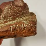 Ceramic relief portraying a lady. Emerging out of the background.