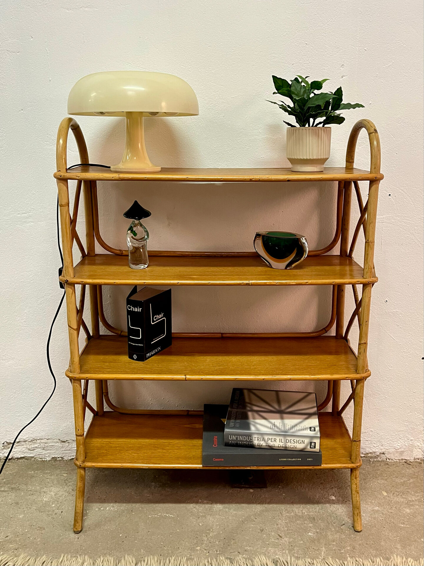 Vintage shelf on legs made of rattan and wood.