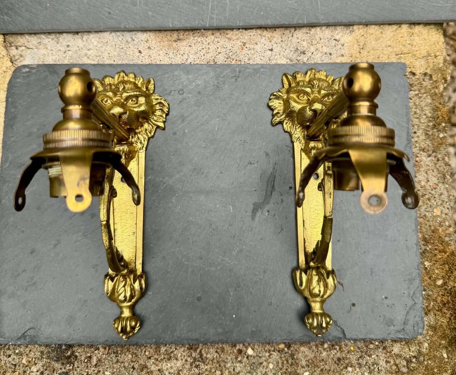 2 brass lion Empire wall sconces
