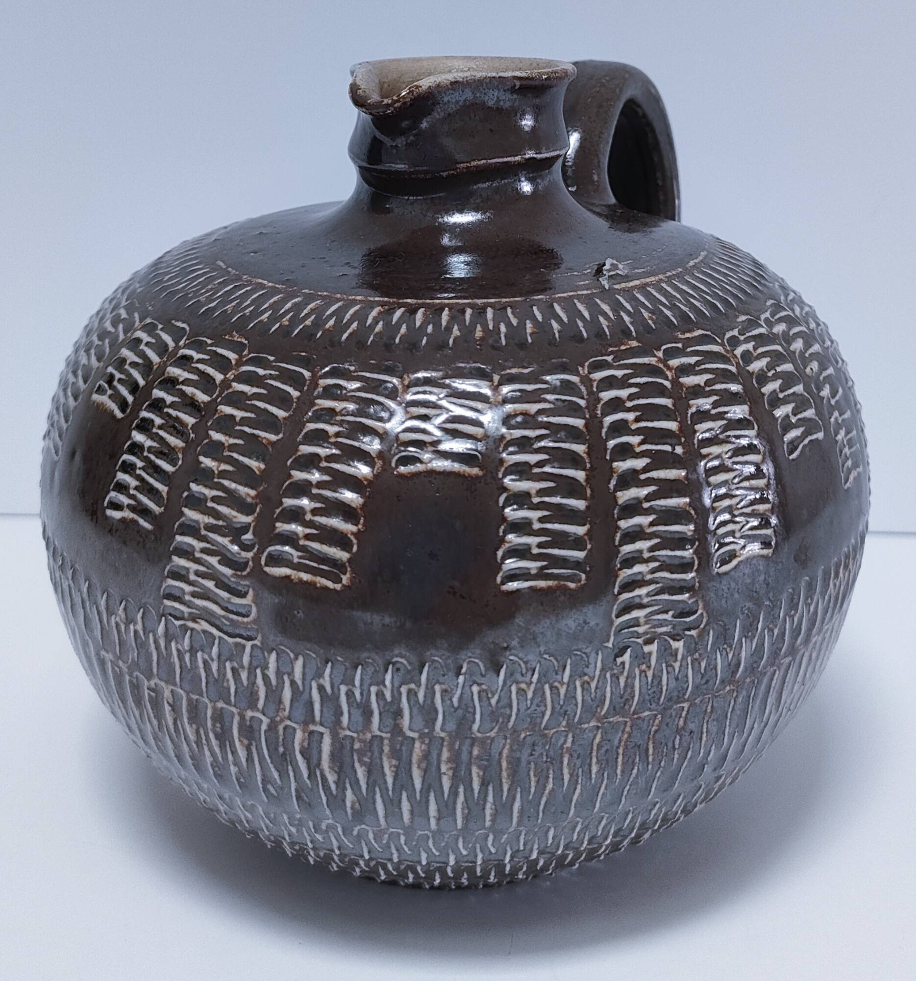 Vintage scarified glazed stoneware pitcher