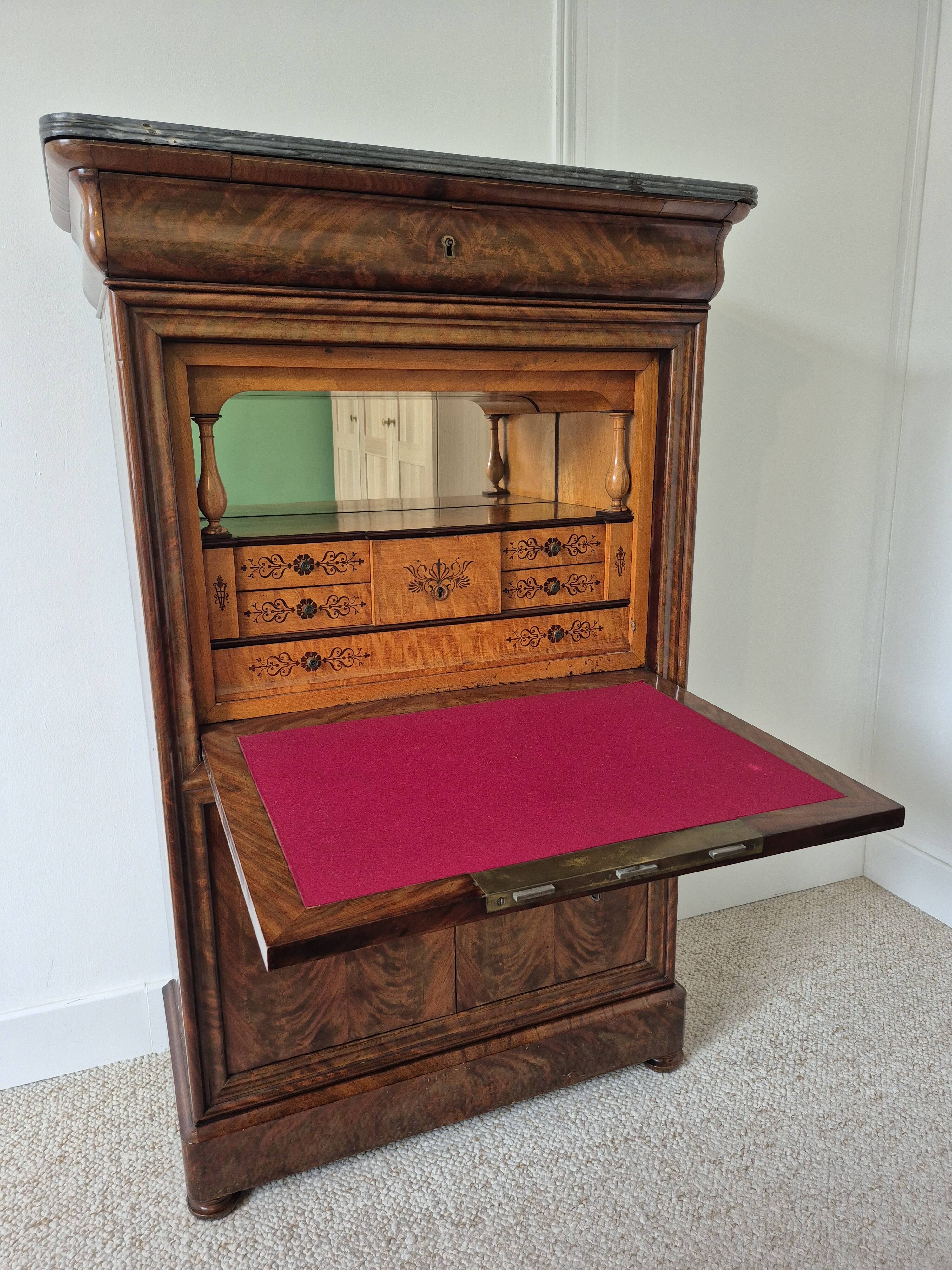 Mahogany secretary desk with marble top and interior mirror.
