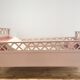 Vintage wooden baby bed in old pink